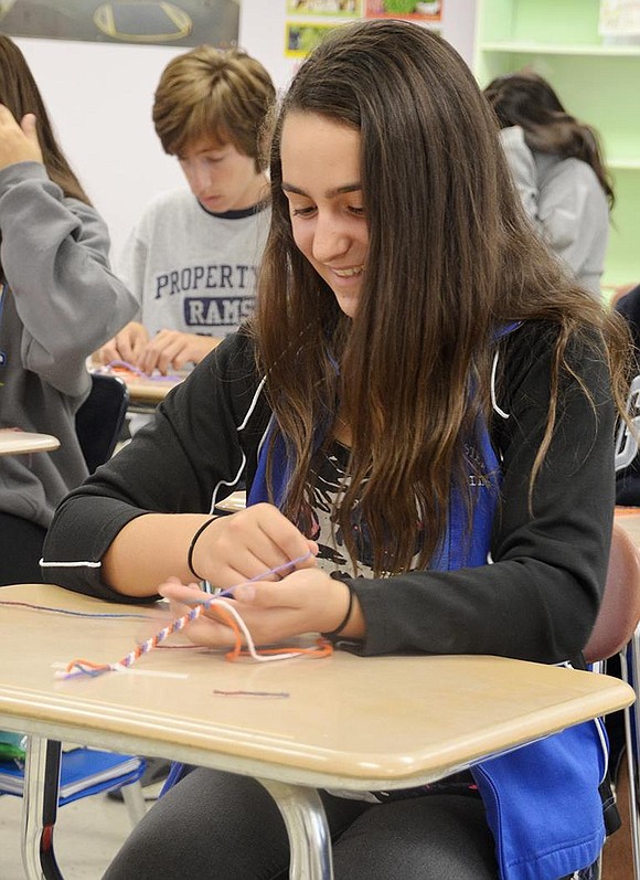  To celebrate the Civil War era pastime of craft making, Jade Lovallo in Cindy Martinez's class makes yarn lanyards. 