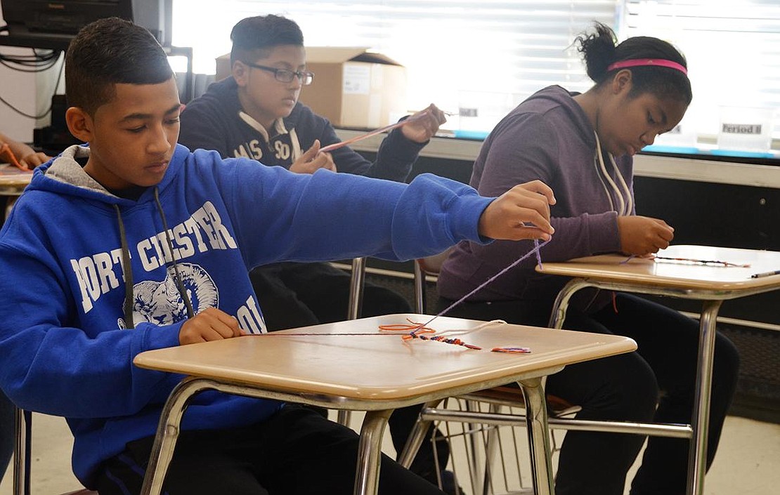  To celebrate the Civil War era pastime of craft making, Ivan Garcia in Cindy Martinez's class makes yarn lanyards. 