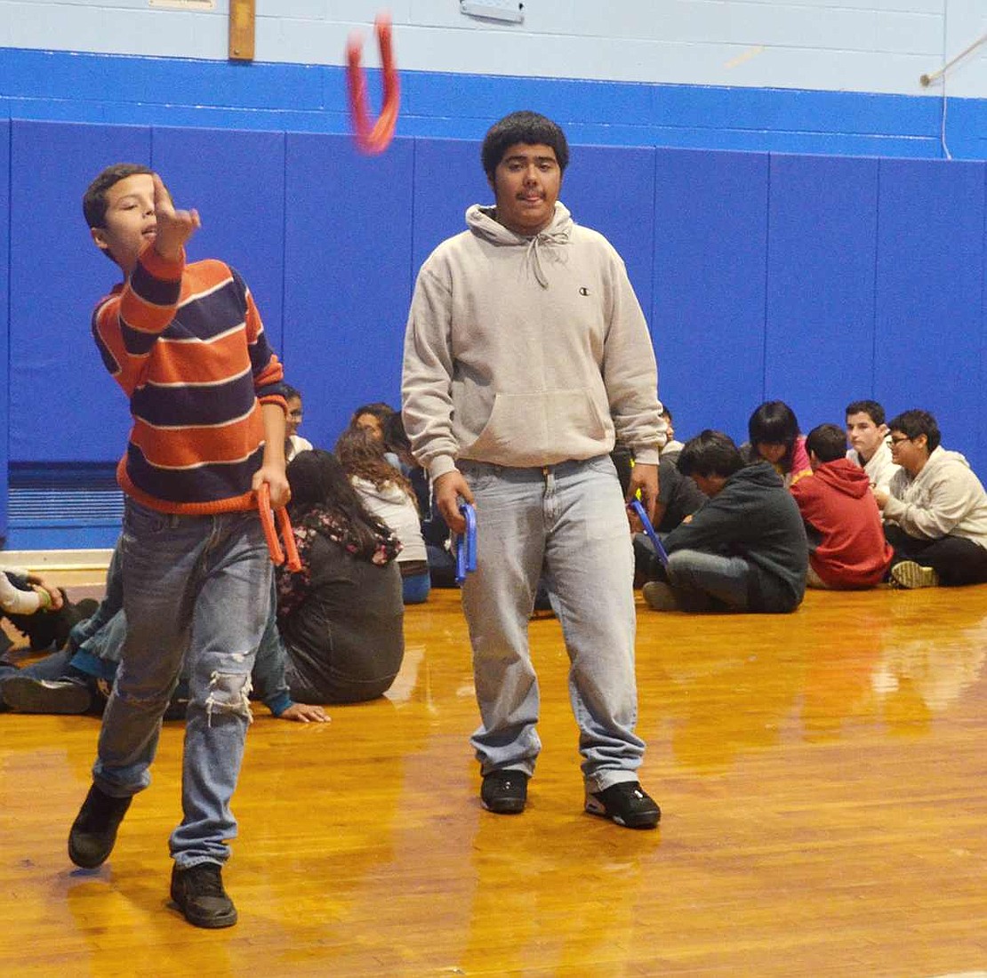  Edwin Santillan tosses a horseshoe while Isaac Monzon waits for his turn. The students got to try out popular games and sports of the 1860s.