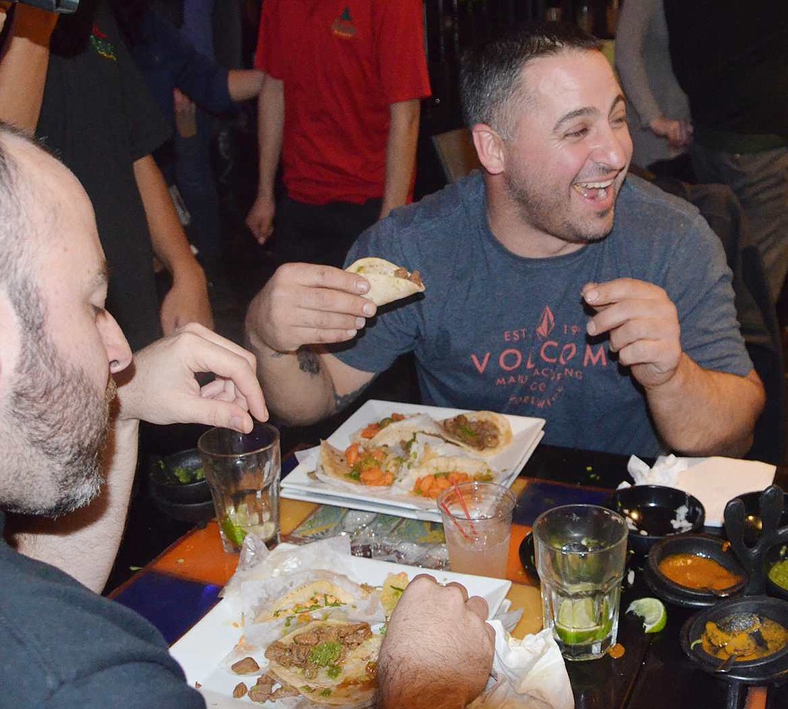 Jon Lovallo of Port Chester jokes around with the other guys participating in the taco-eating contest at Salsa Picante on Monday, Nov. 9.