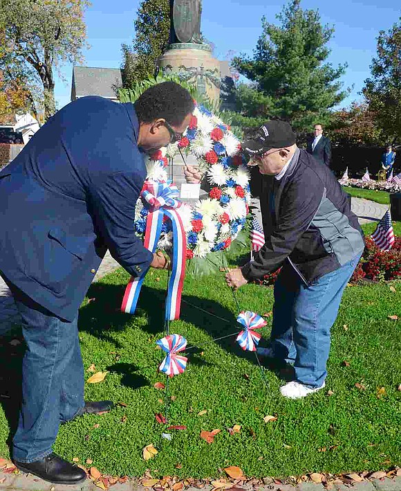  Port Chester Village Manager Chris Steers and Bishop Nowotnik, confidential secretary to the Rye Town supervisor, place a wreath in front of the central monument at Veterans' Memorial Park during the Port Chester-Rye Brook-Rye Town Veterans Day ceremony on Sunday, Nov. 8.