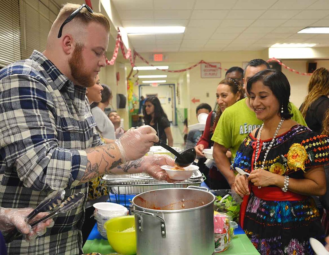 Matt Casey, a special education aide at Edison School, dishes up a bowl of posole Mexican soup. 