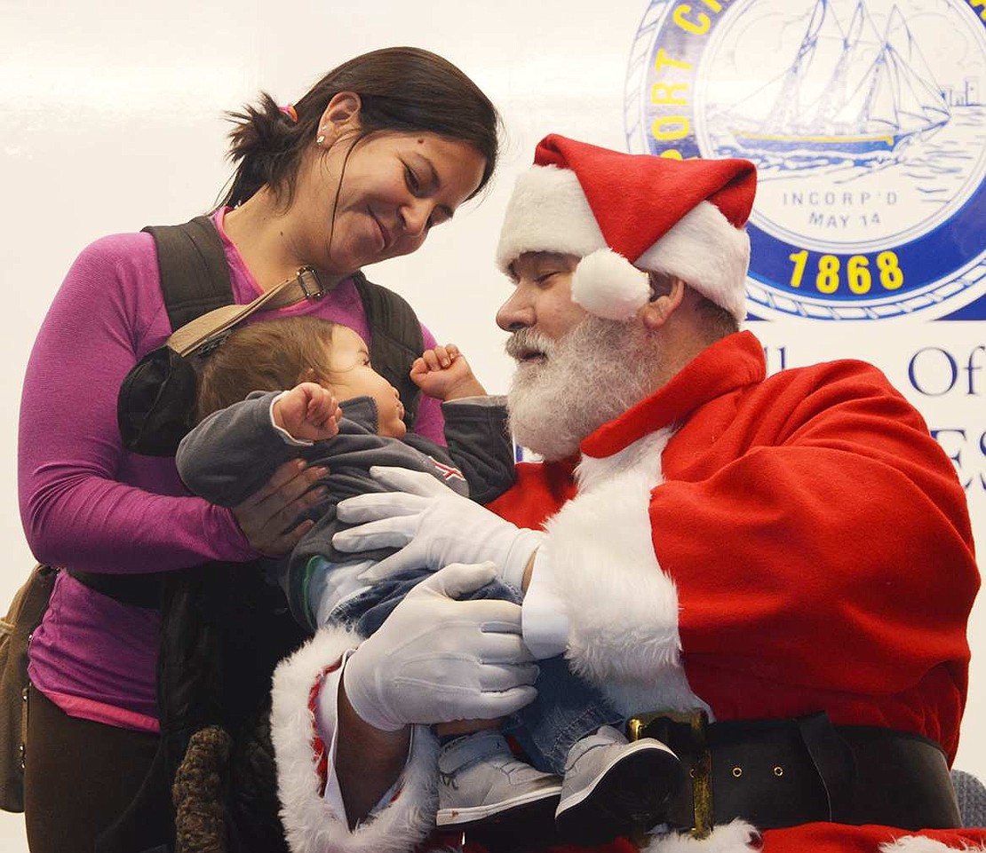  Port Chester's Maria Torres introduces her son Rudy to Santa for the first time. With a jolly chuckle, Charlie Sacco greeted the many children who showed up to the annual Santa in the Park at Lyon Park on Thursday, Dec. 10. 