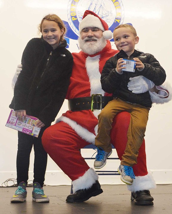  Alexandra Beatty, 9, and brother Matthew, 5, of Mitchell Place pose with Santa, played by Port Chester's Charlie Sacco. 