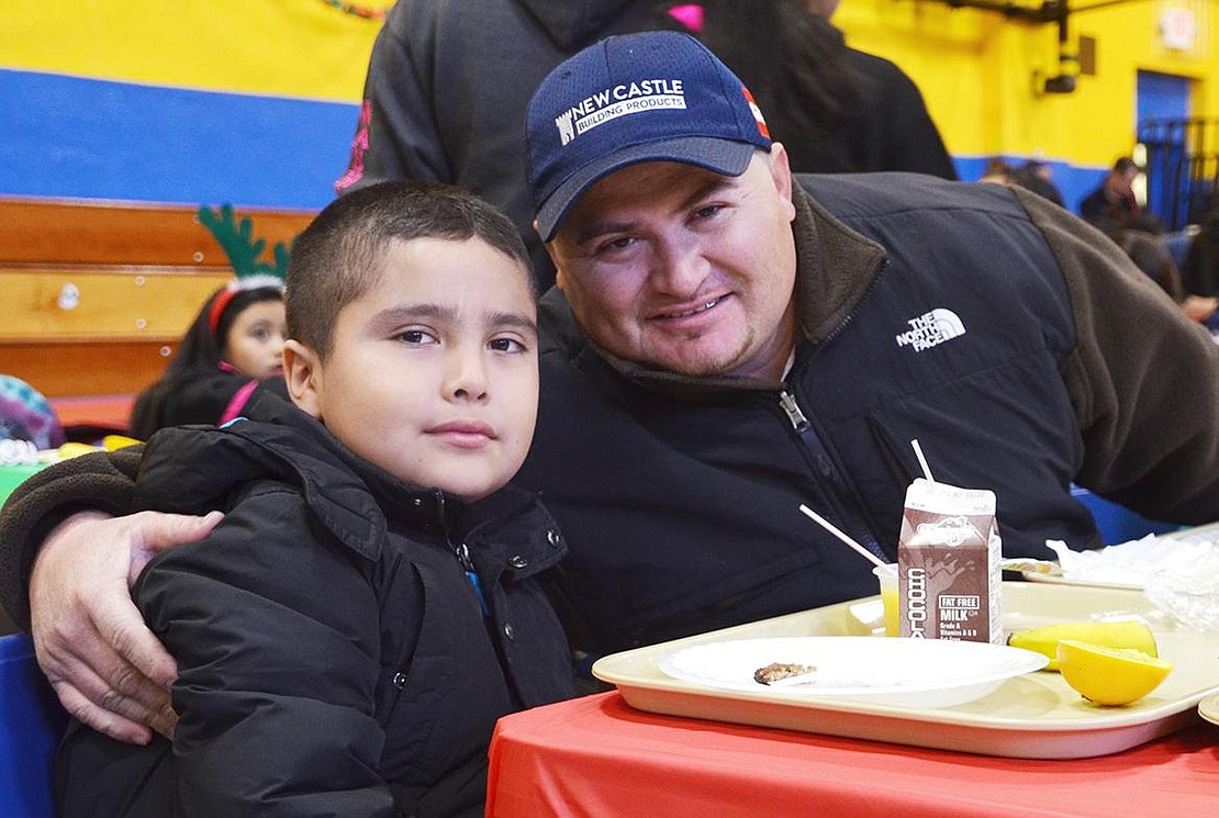  Jos&#233; Alvarez of South Regent Street and his son Joseph enjoy breakfast together at the Don Bosco Center. 