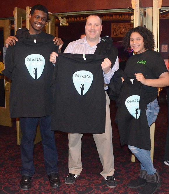 <p class="Picture">Onya Solomon, Carver Center Aquatics, Recreation and Fitness Director Jeff Cunningham and Jaelynn Finklea hold up Concert for Carver t-shirts that were for sale.&nbsp;</p>