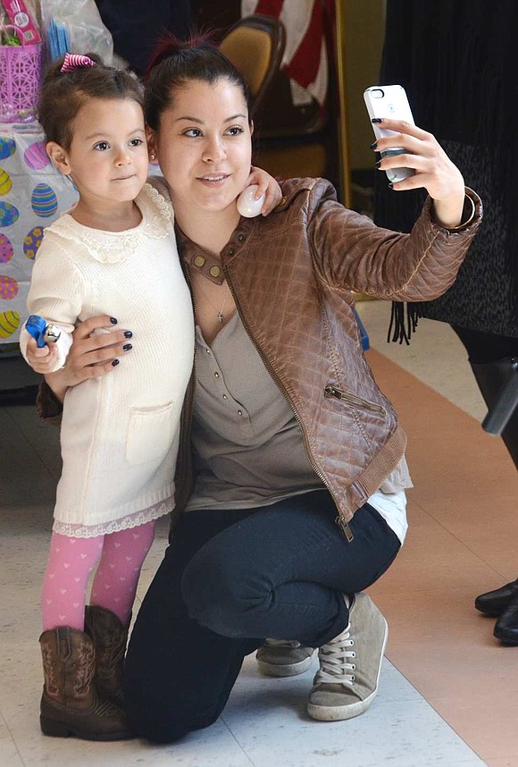 <p class="Picture">Claudia Ceja of Roanoke Avenue takes a picture of herself and her daughter Emiliana, 3, with her cell phone at this year&rsquo;s Lunch with the Bunny event at Posillipo Center on Saturday, Mar. 19.</p>