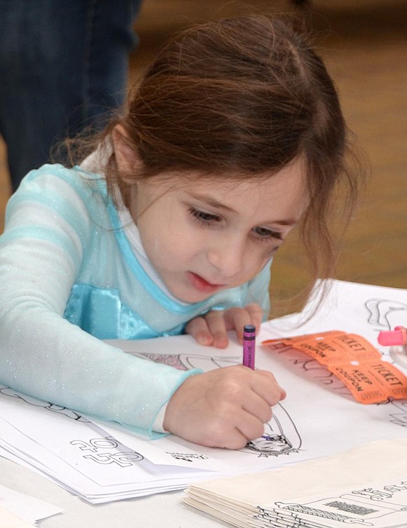 <p class="Picture">Aerin Tauber, 5, of Rye Brook colors a picture of Queen Esther.</p>