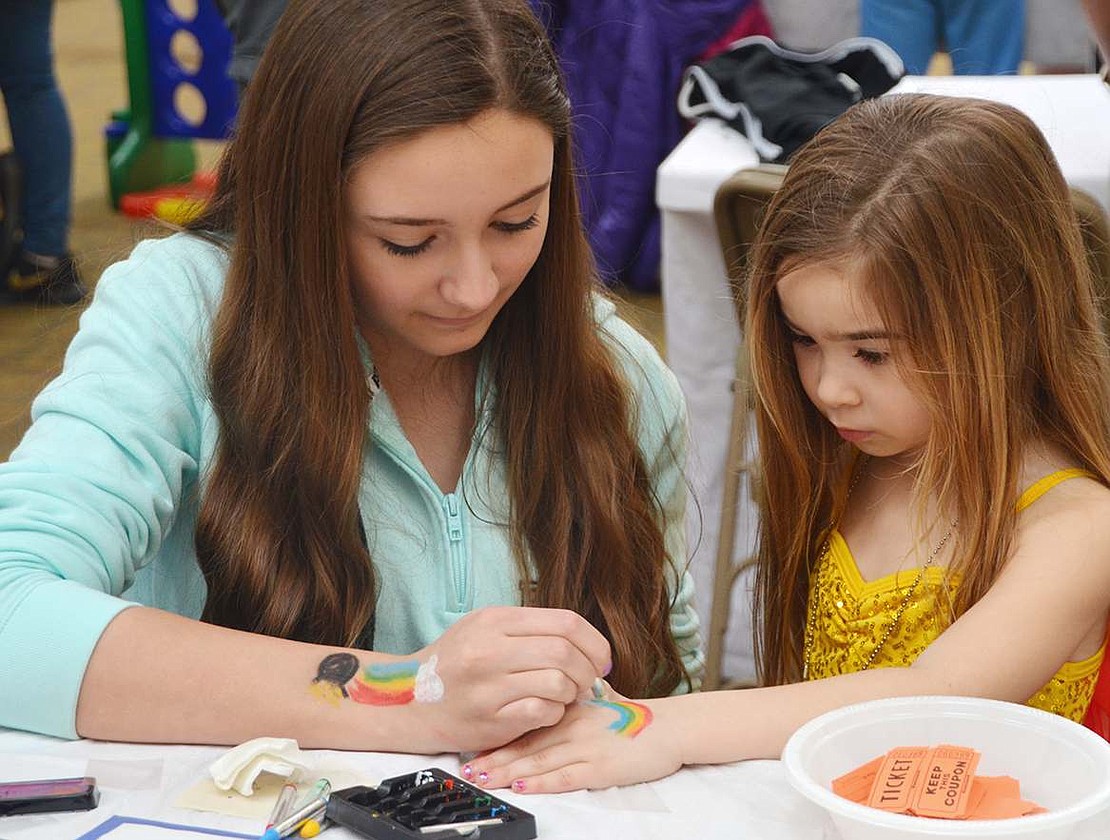 <p class="Picture">Emma Stevens, 14, of Paddock Road paints a rainbow on the hand of Hayden Sassower of Rye Brook at the Purim Carnival at Congregation KTI in Port Chester on Sunday, Mar. 20.</p>