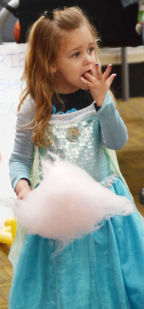 <p class="Picture">Dressed as Queen Esther, Layla Brown, 3, of Rye Brook, who attends KTI&rsquo;s Early Childhood Program, licks her sticky fingers as she makes her way through a cone of cotton candy.</p>