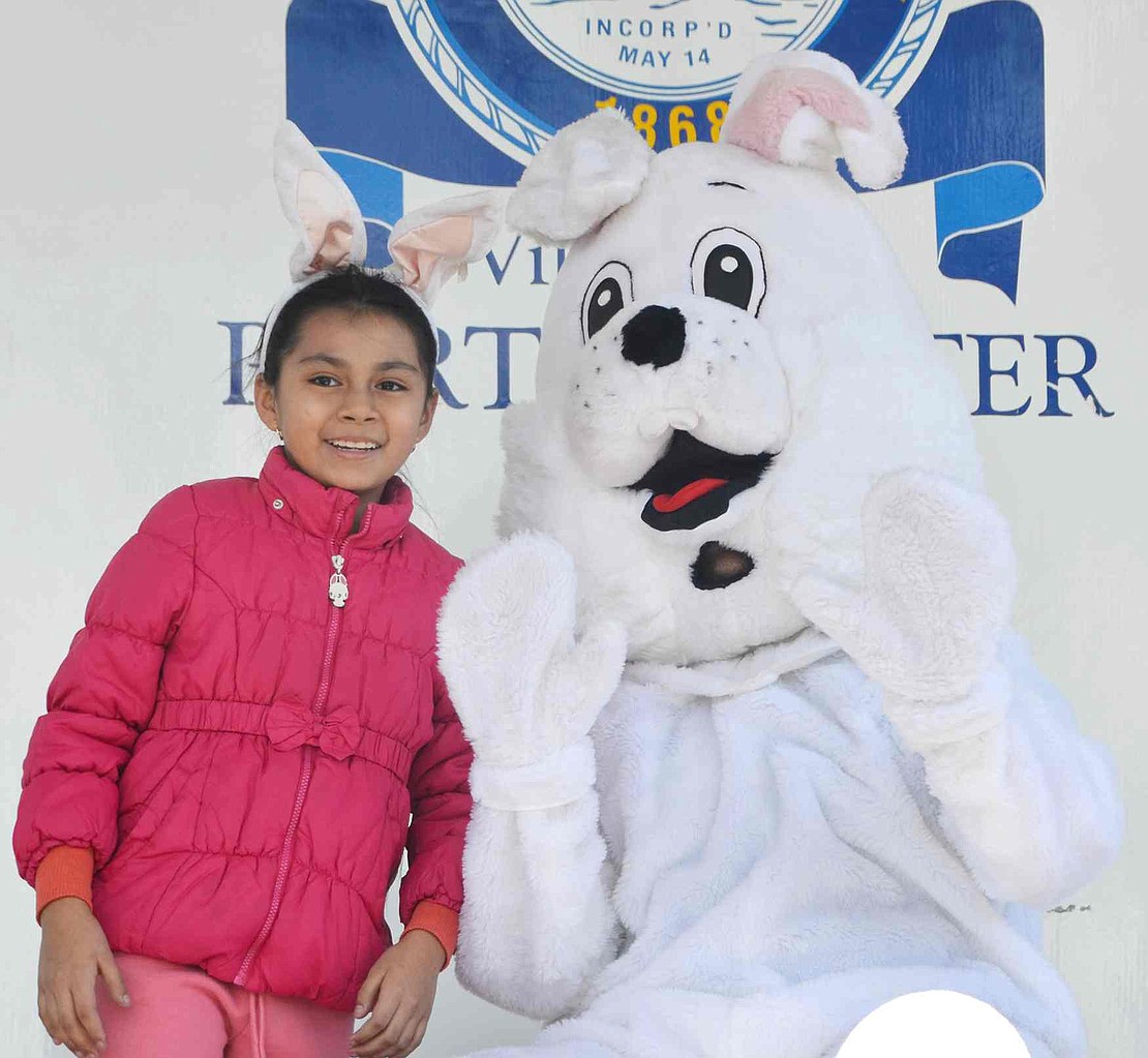 <p class="Picture">With her own set of ears atop her head, Giselle Tlatepa, a Port Chester 9-year-old, smiles with the Easter Bunny, who was played by Phil Nosal of White Plains.&nbsp;</p>