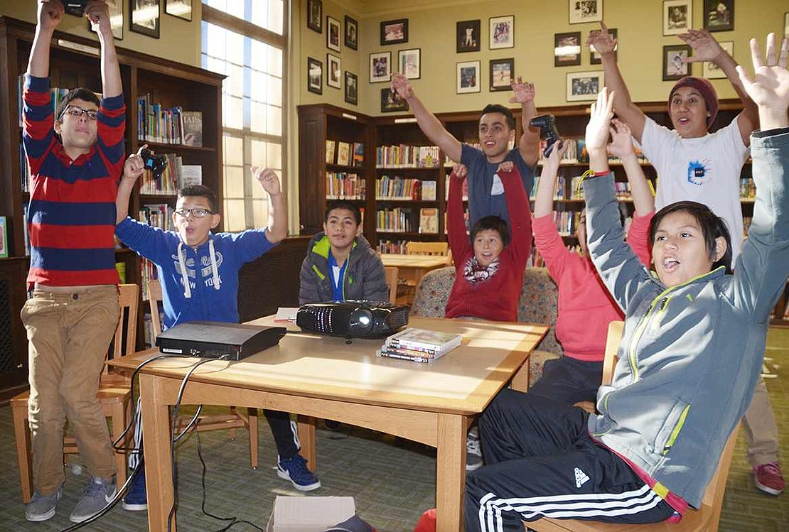  Local teenagers celebrate scoring a goal on the FIFA game on the PlayStation 3.