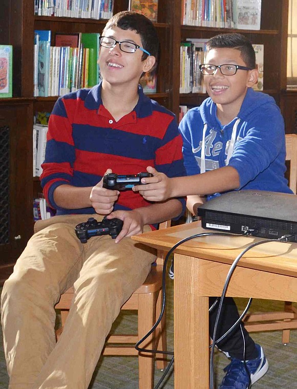  Both on team Portugal, Port Chester 13-year-olds Fernando Cardenas and Jonathan Gonzalez choose players for the next soccer match. Local children and teens gathered at the Port Chester-Rye Brook Public Library on Saturday, Nov. 21 as part of International Gaming Day. 