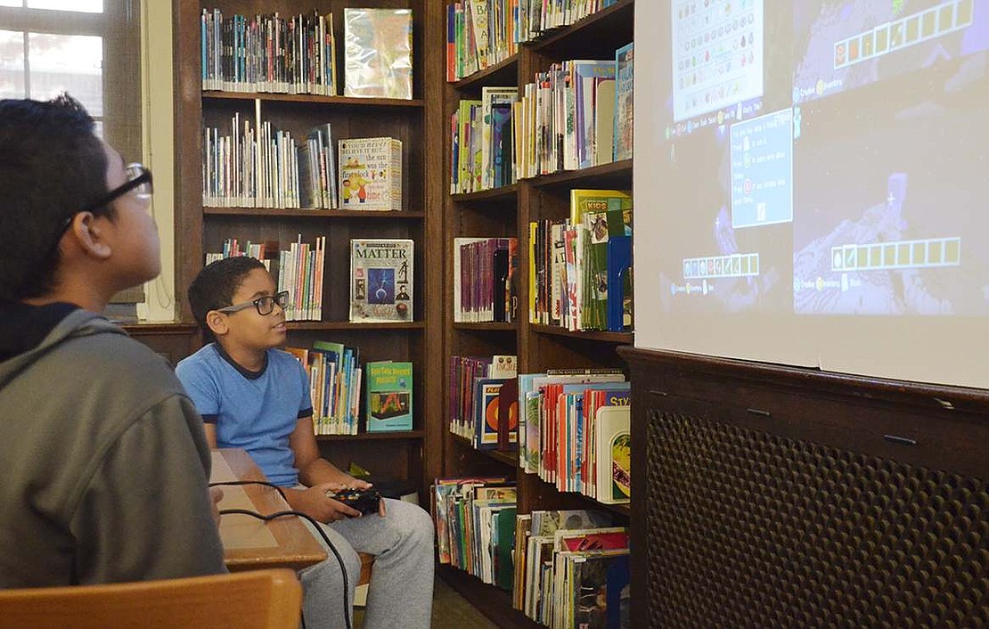  Nine-year-old Vladimir Almonite of Port Chester plays Minecraft with his friends on the Xbox 360. 