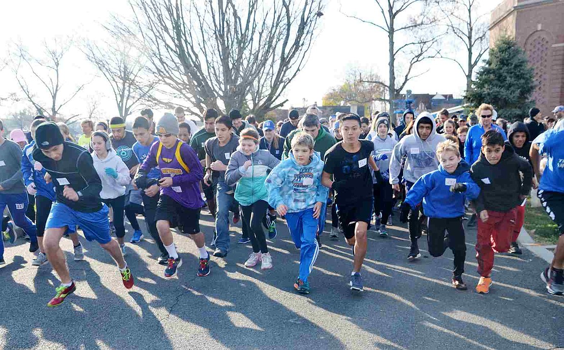  More than 300 runners and walkers, some with dogs and some pushing baby carriages, take off from the starting and ending line for the Tamarack Tower Foundation's annual Turkey Trot adjacent to the flagpole at Port Chester High School.  