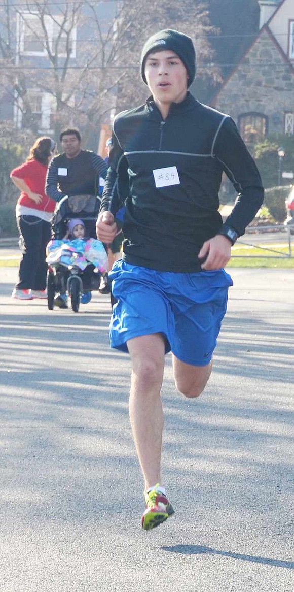  Track star Leonard Pietrafesa, a Port Chester High School senior, is the first person over the finish line in the Tamarack Tower Foundation's annual Turkey Trot, a 3.5-kilometer race, on Thanksgiving morning. 