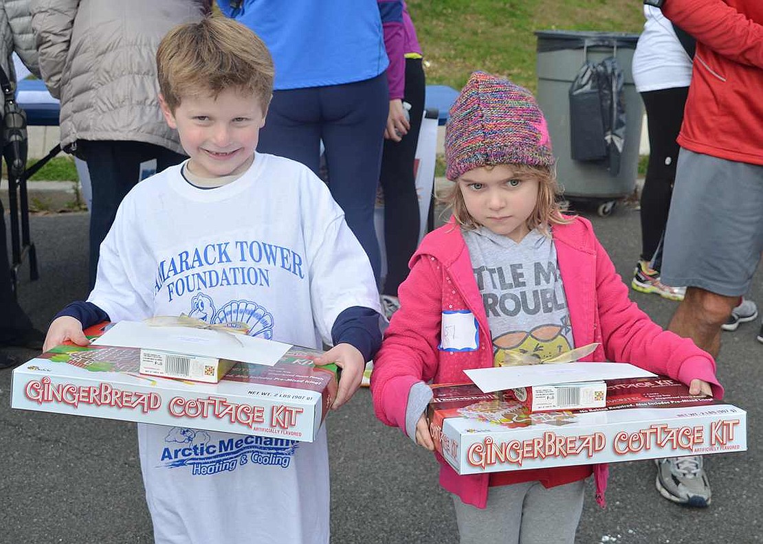  Six-year-olds Trevor Feist and Carlee Gabriel of Rye Brook display the prizes they won for being the youngest Turkey Trot participants. 