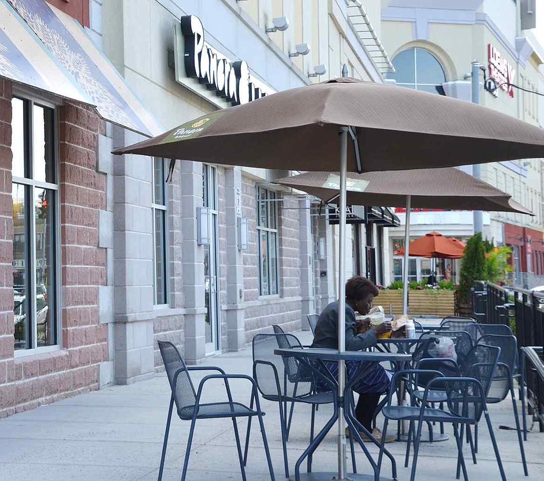  Umbrella-shaded tables in front of Panera Bread