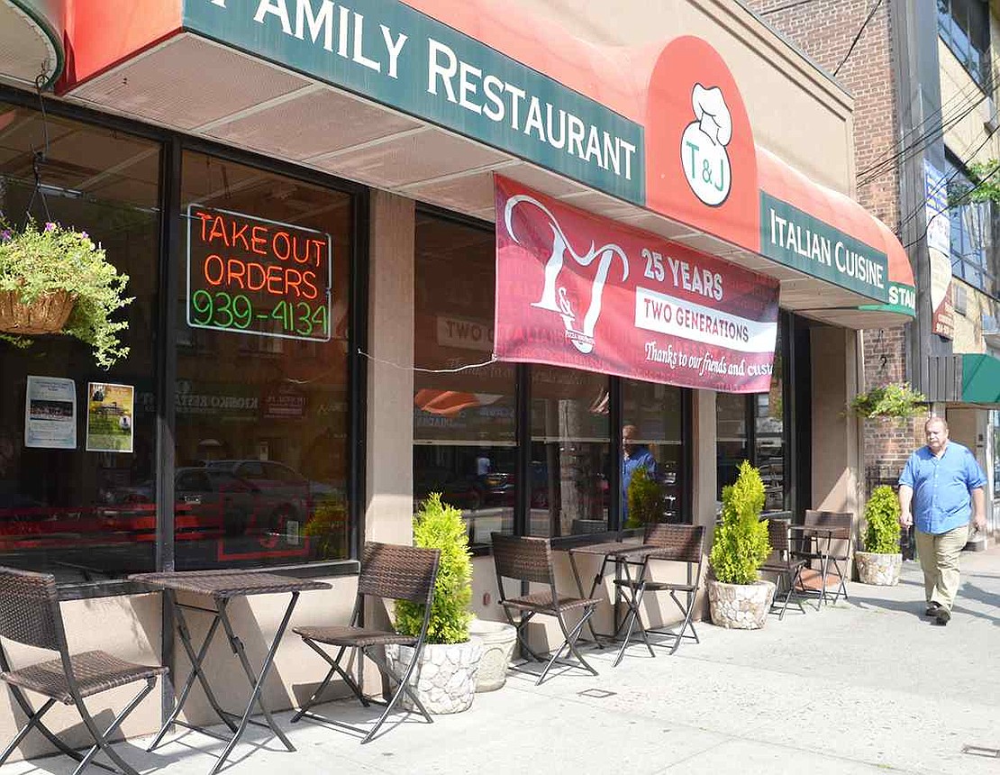  Tables set up on the sidewalk outside T&J Pizza & Pasta