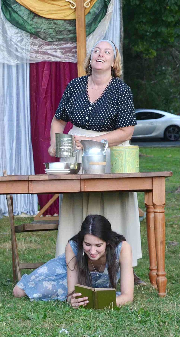 While her nurse bakes, Juliet reads a book underneath the table. Julie Thaxter-Gourlay of Port Chester and Claire Hilton of Darien, Conn. both star in the LawnChair Theatre production of William Shakespeare's Romeo and Juliet.