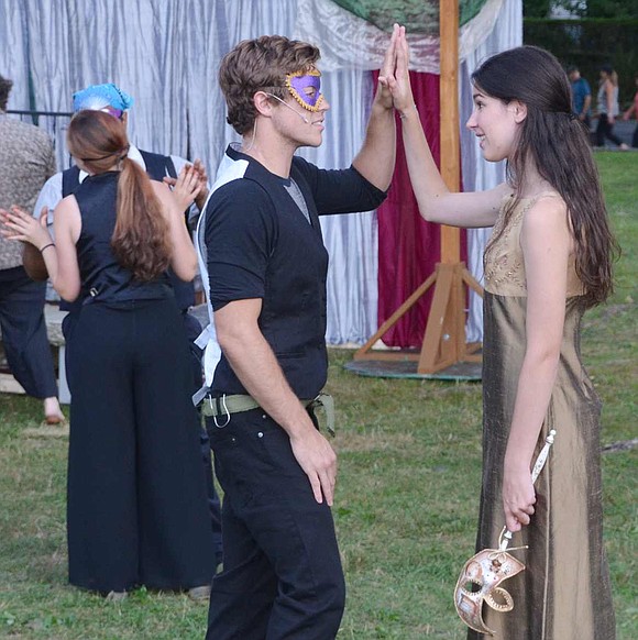 At a party, Romeo and Juliet meet for the first time and "palm to palm is holy palmers' kiss."  Monty Renfrow of New York City and Claire Hilton of Darien, Conn. both star in the LawnChair Theatre production of William Shakespeare's Romeo and Juliet.