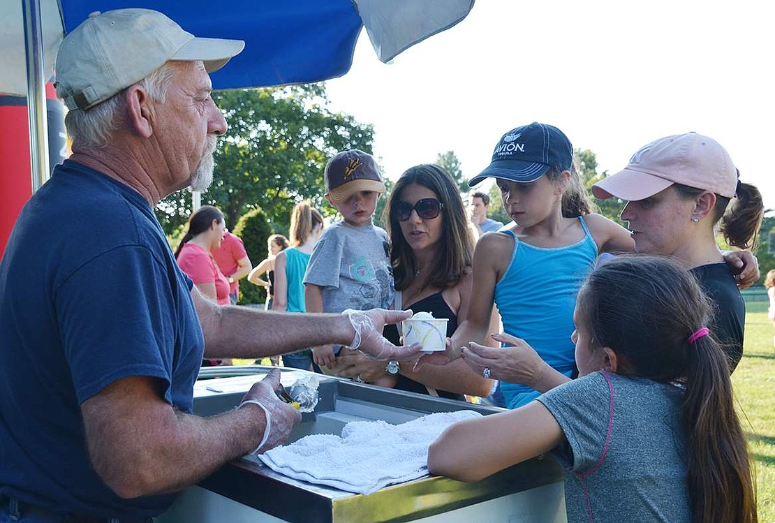 Ted Warzoha from the Rye Brook Parks and Recreation Department hands out free scoops of ice cream and Italian ices.