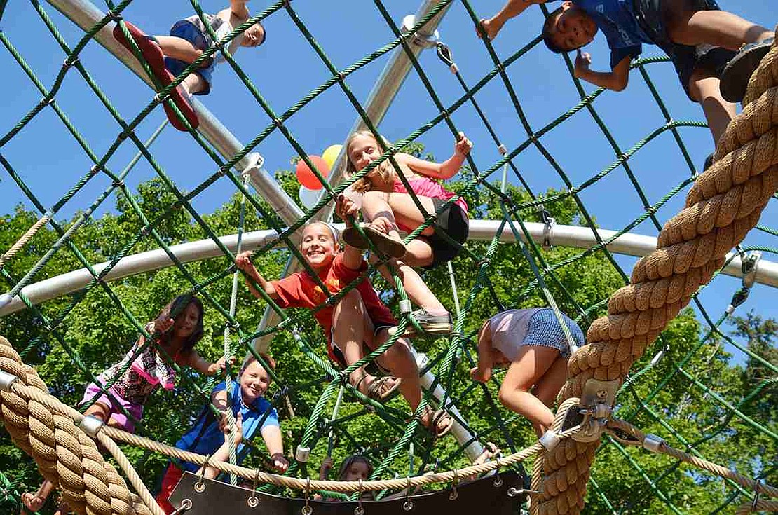Rye Brook children climb all over a dome covered in nets and ropes, one of the new pieces of playground equipment at Pine Ridge Park on Friday, Aug. 7. 