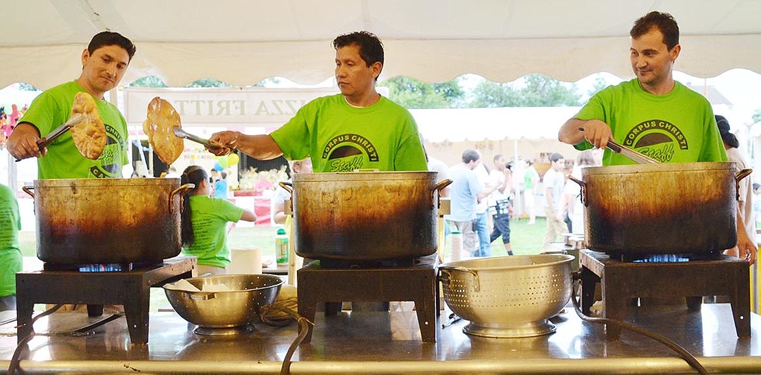 Three Port Chester men volunteer their time frying up pizza fritta at the carnival. From left: Juan Carlos , Miynor Ramirez and Fauzzy Lopes. 