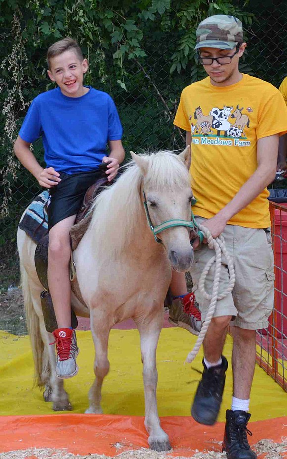 Port Chester 10-year-old Antonio Cabibbo rides a pony, something new at the carnival this year. 