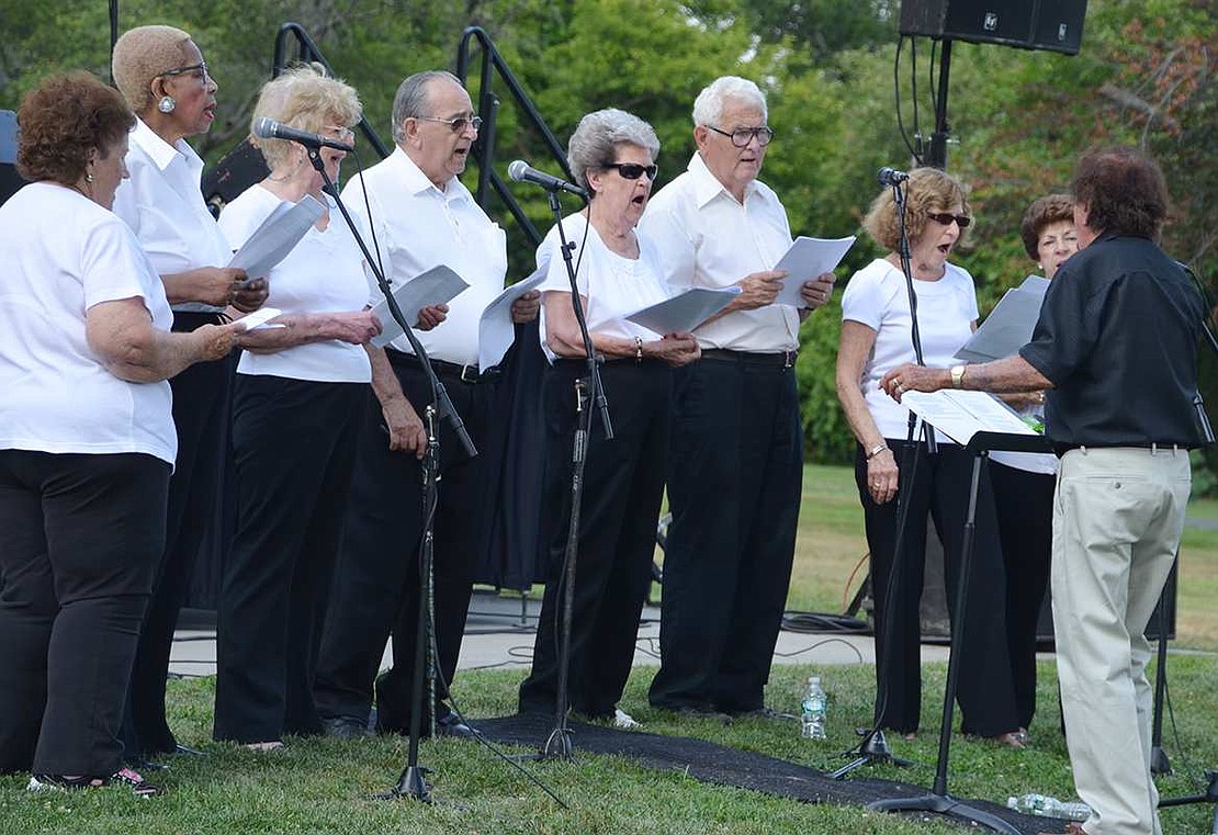  The Port Chester Senior Chorus, led by Ang Rubino, serenades attendees. 