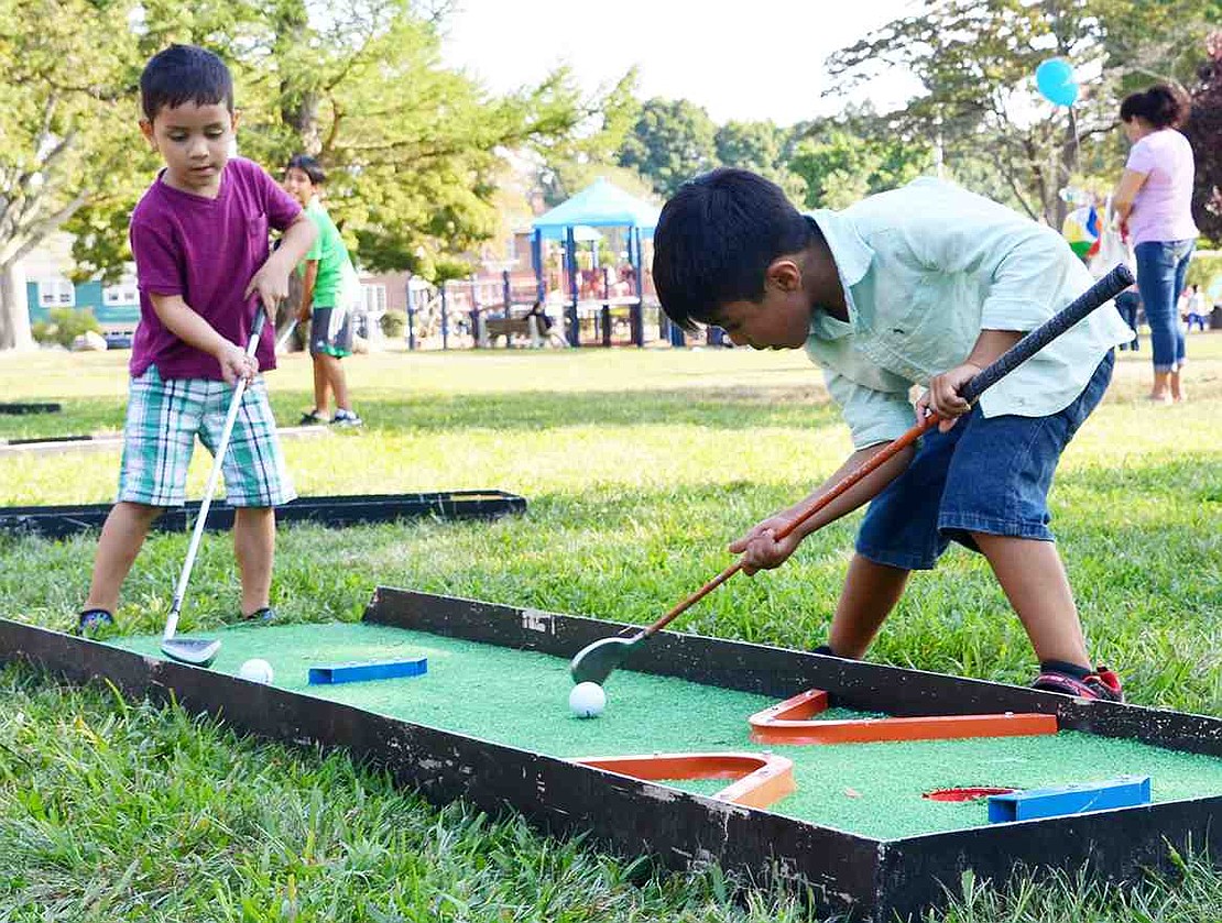  A bit puzzled by putt-putt, James Rodriguez and Andy Ramirez try to play miniature golf. The Port Chester boys struggled with the putters but had fun anyway. 