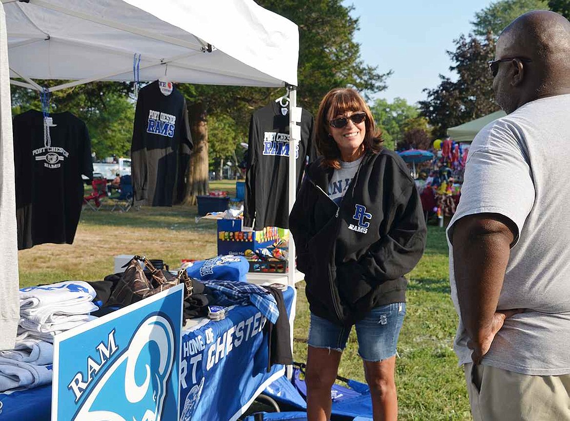  Miriam Valbiro of Birch Street asks Skip Wilson of Bridgeport, Conn. for his opinion on the Port Chester Rams sweatshirt she is considering buying.  