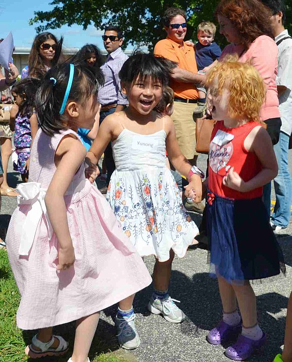  New friends Maggie Miao (left), Yunong "Melody" Wu and Julia Fagan hold hands as they jump in excitement before getting on the school bus for the first time. All of the kindergartners at Ridge Street School met up on Thursday, Aug. 27 to hang out before school started on Wednesday, Sept. 2. 