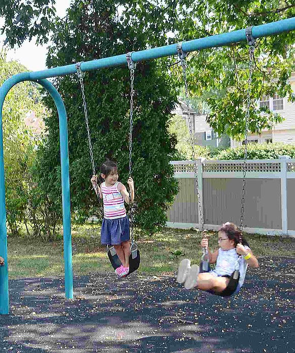  Lily Connard and Zoe Lopez play on the swings. The neighbors will be entering different kindergarten classes with Connard learning from Fatima Barnett and Lopez from Laurie Glockenberg. 