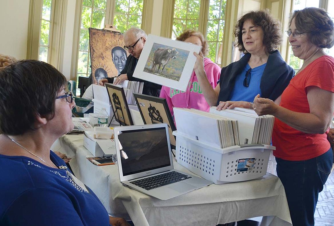  Rye Brook resident Pat Wagner tells Lisa Lipman of Port Chester and Harriet Barish of Mamaroneck the story behind her picture of a happy cow. A dozen local artists with ties to Rye Town gathered at Crawford Mansion on Sunday, Oct. 4 to show their work at the 5th annual ART10573 show organized by the Port Chester Council for the Arts.