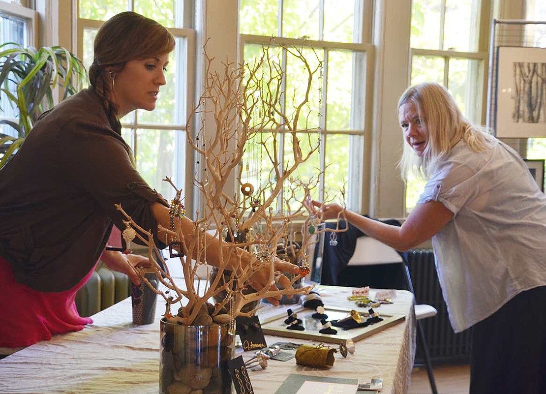  Jennifer Marie Headrick (left) points out one of the pairs of earrings she created to Peggy Romanello, a former Port Chester resident who now lives in North Salem. 