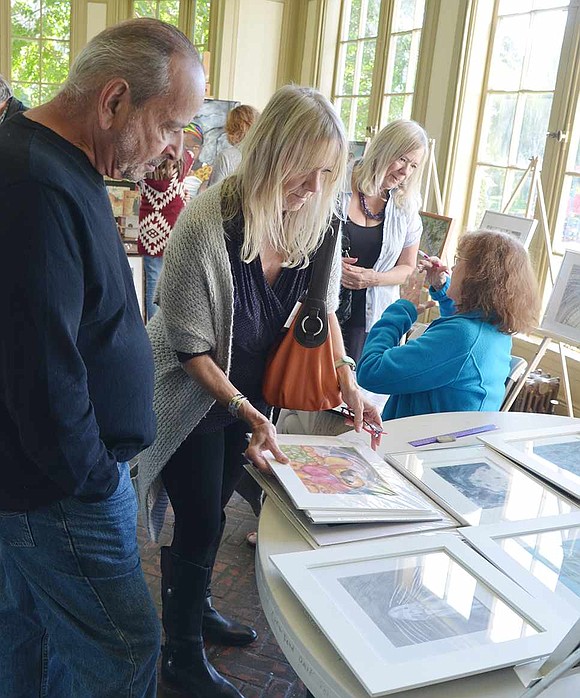  Attendees look through some of the watercolors done by Port Chester High School art teacher April Dessereau.