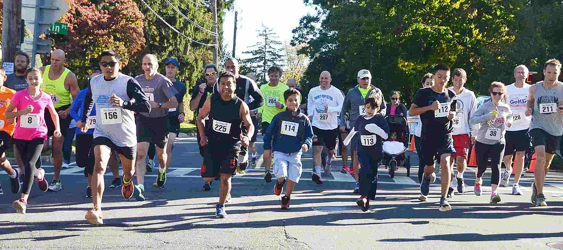 About 40 people take off from the starting line on Putnam Avenue on Saturday morning, Oct. 10 for the 17th annual Port Chester 5K run/walk. The Port Chester Recreation Department raised about $1,300 for the Port Chester/Rye Brook ARC, which supports individuals with special needs.