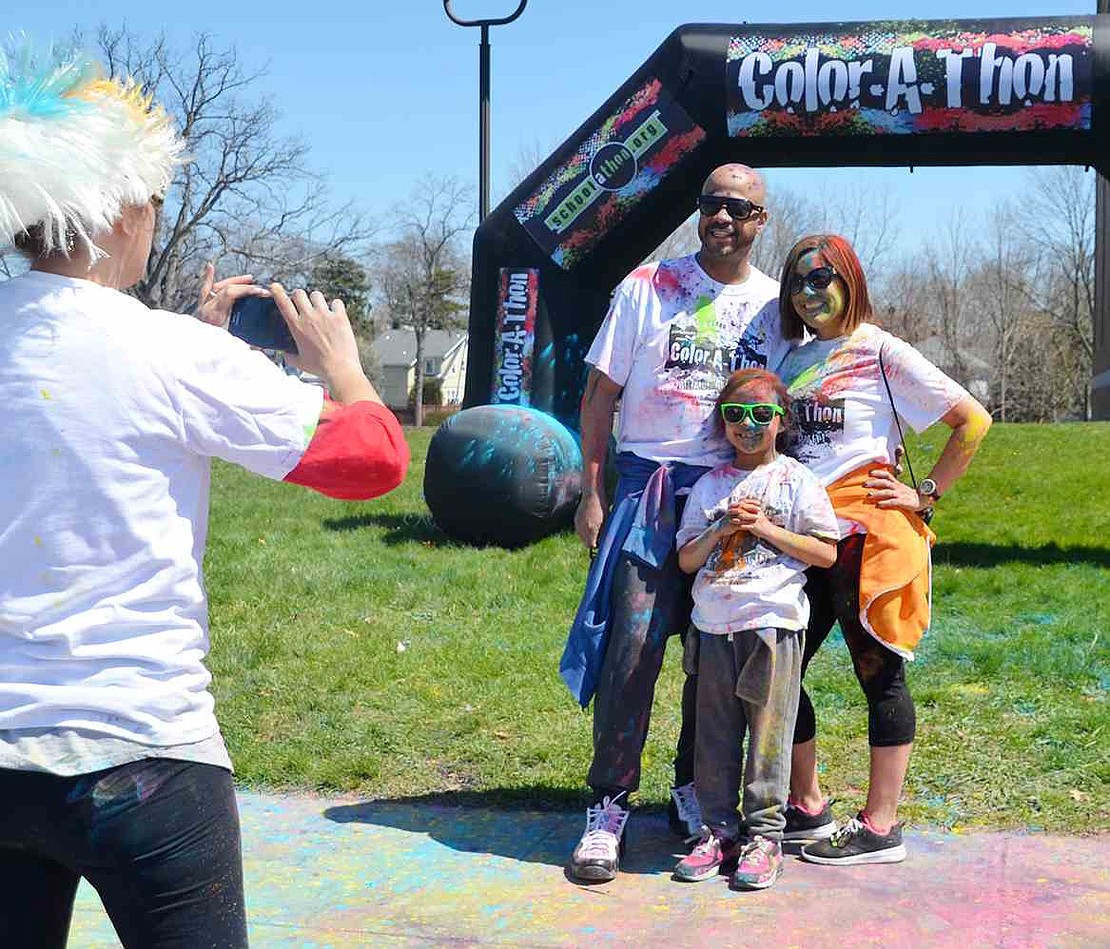 <p class="Picture">After completing their four laps around Park Avenue School, the Fuentes family&mdash;Louis, Gwendy and first-grader Chloe&mdash;pose for a photo.&nbsp;</p>