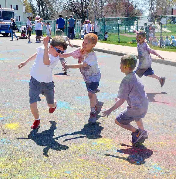 <p class="Picture">A latecomer to the Color-A-Thon tries to evade some of his friends determined to catch him, hug him and transfer some of the color from them to his clean, white t-shirt.&nbsp;&nbsp;</p>