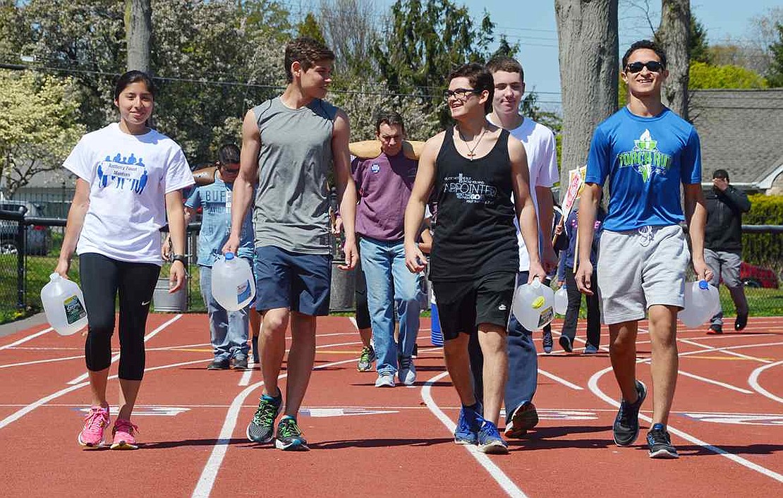 <p class="Picture">Port Chester High School students, many of them Anthony Foust mentors, walk around the track at their school.</p>