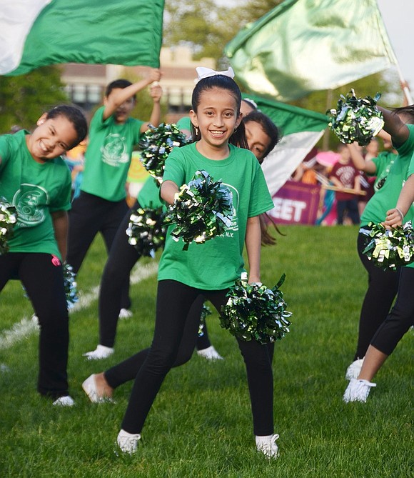 <p class="Picture">Thomas A. Edison School fifth-grader Anahi Cabrera shakes her sparkly green pom-poms.&nbsp;</p>