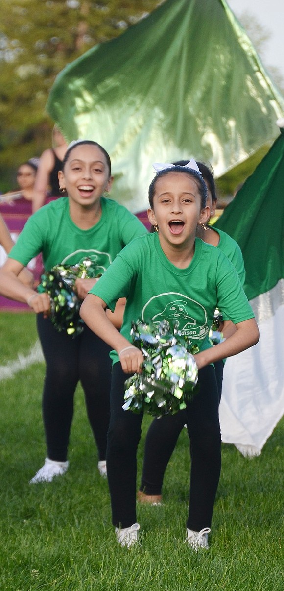 <p class="Picture">Thomas A. Edison School fifth-grader Anahi Cabrera shakes her sparkly green pom-poms.&nbsp;</p>