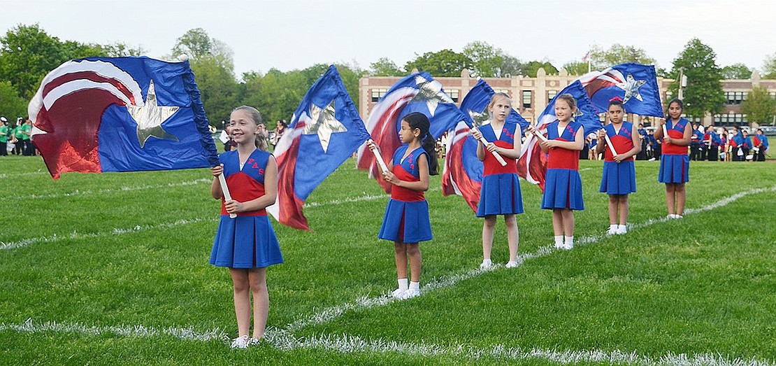 <p class="Picture">Waving flags, Park Avenue School students perform on the athletic field across the street from their elementary school. From left: Natalie Ceruzzi, Elizabeth Magana, Shea Hollwedel, Cameron Caie, Kenia Gomez and Isabella Rivera.</p>