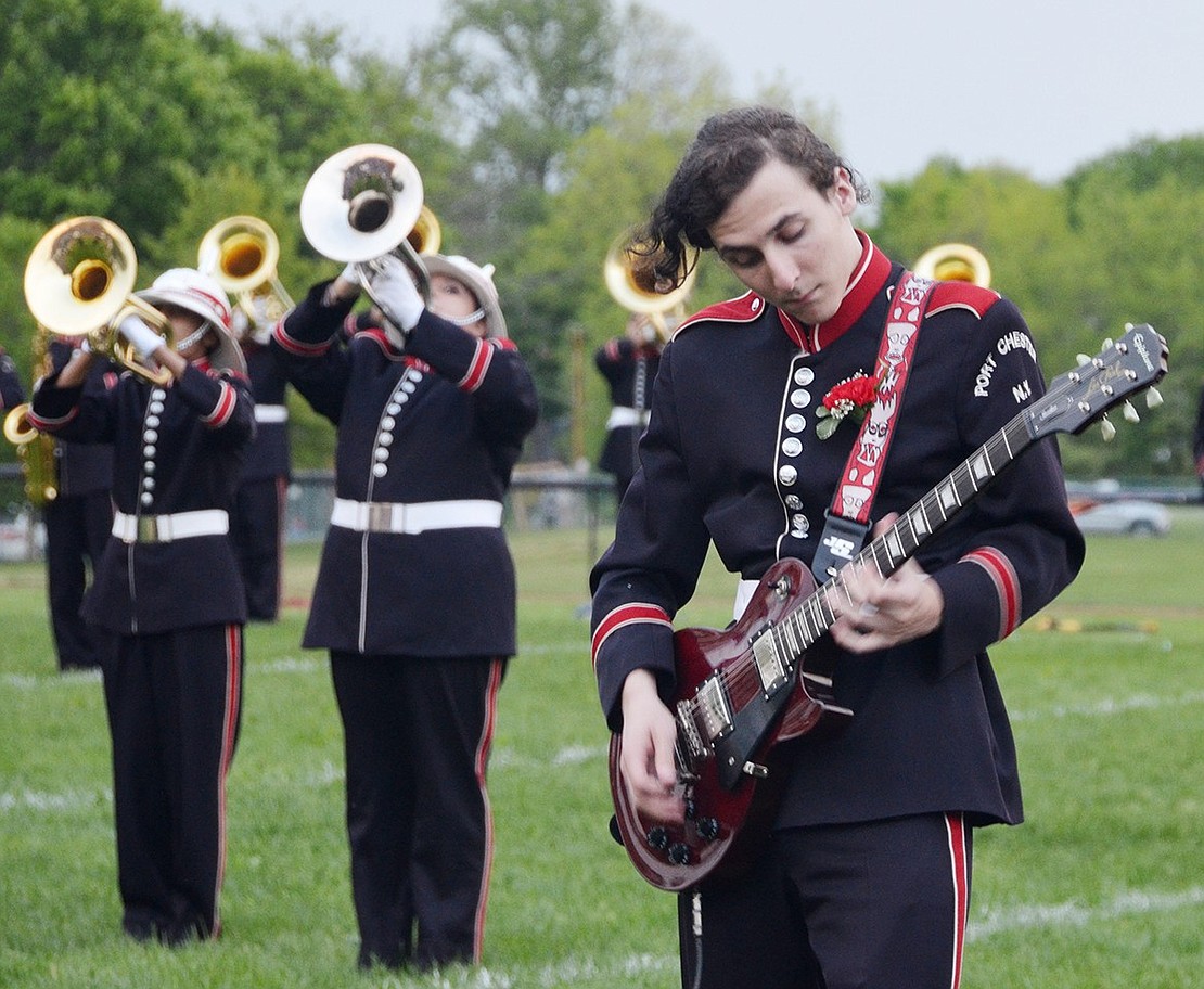 <p class="Picture">For that added rock element, Colby Quinlan, a senior, plays the electric guitar during the Port Chester High School Marching Band&rsquo;s Queen-themed field show.&nbsp;</p>