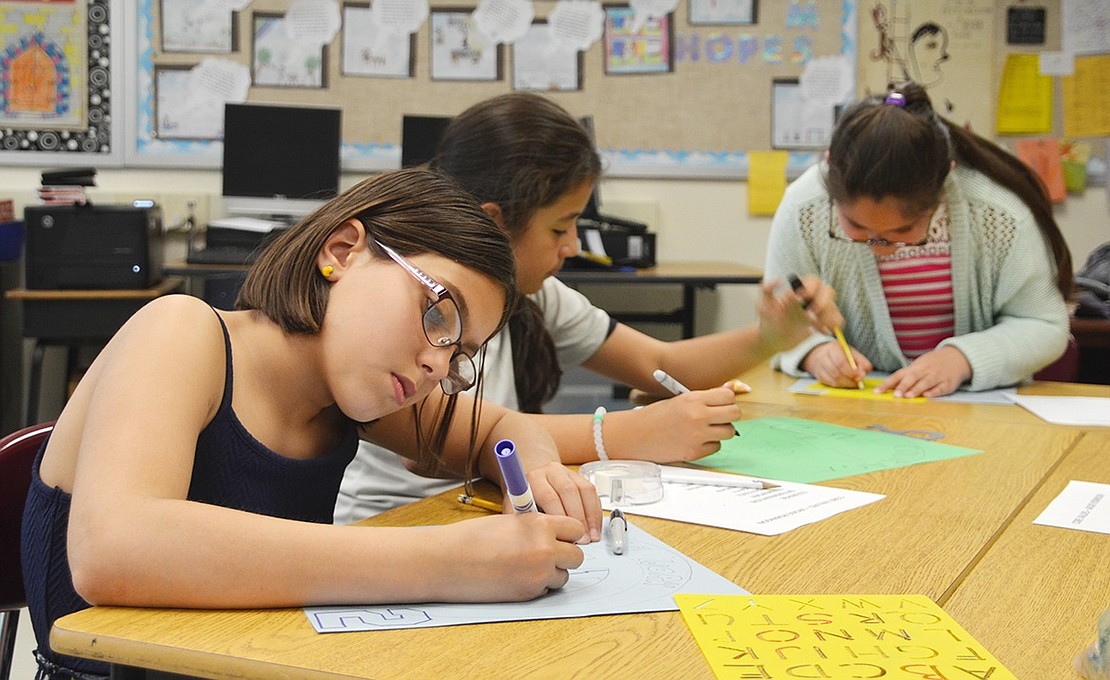 <p class="Picture">Destiny Dominguez (left), a King Street School fourth grader in Maria Laina Sileo&rsquo;s class, carefully uses a marker to color in a drawing.&nbsp;</p>