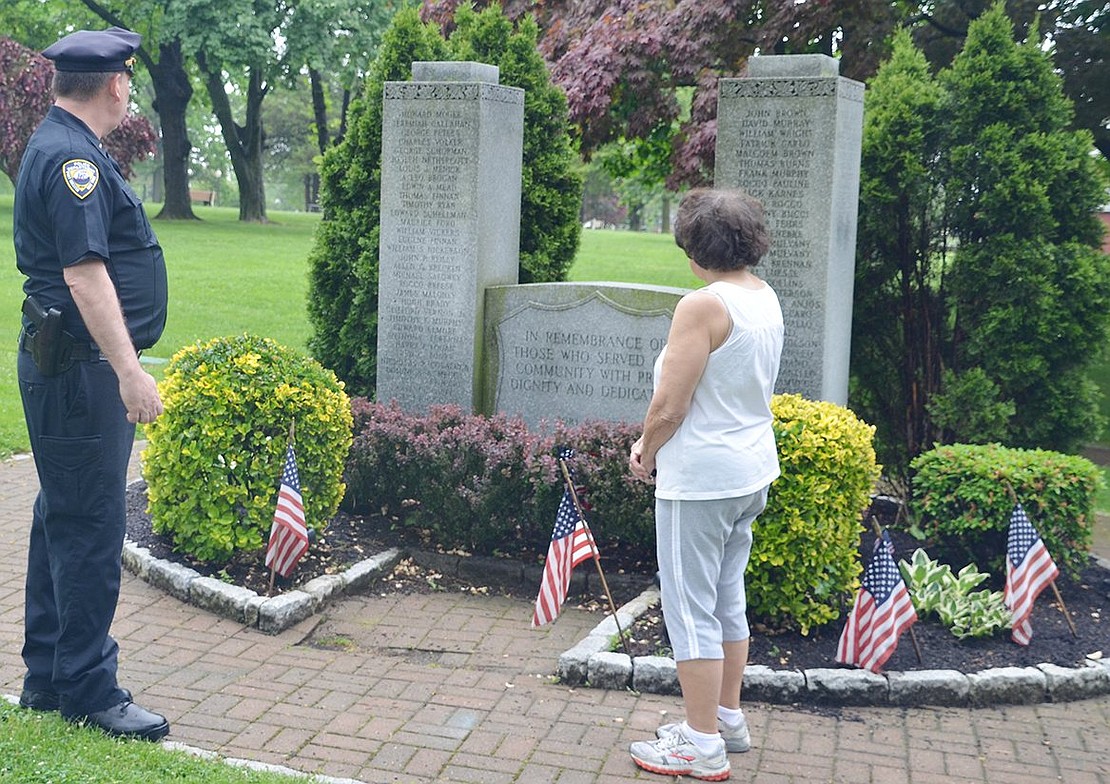 <p class="Picture">Sandy Dutra, widow of Port Chester Police Detective Bill Dutra, stands with Lieutenant Charles Nielsen in front of the police memorial in Lyon Park honoring members of the police force who have died.</p>