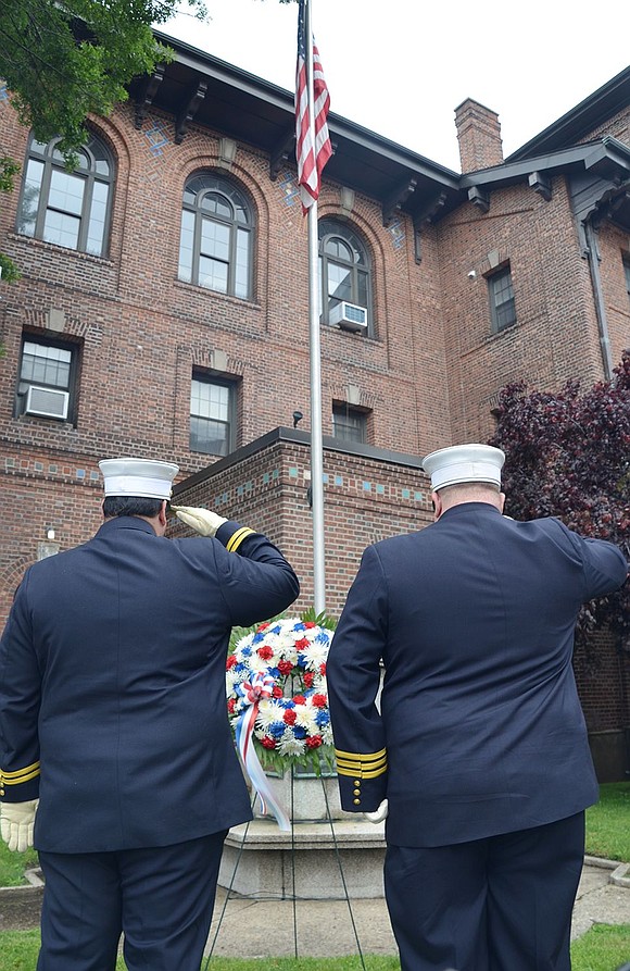 <p class="Picture">Assistant Fire Chiefs <span style="background:white;">Enrico Castarella and </span>Michael De Vittorio salute during the ceremony at the monument to fallen firefighters in front of Fire Headquarters at Westchester Avenue and Poningo Street.</p>