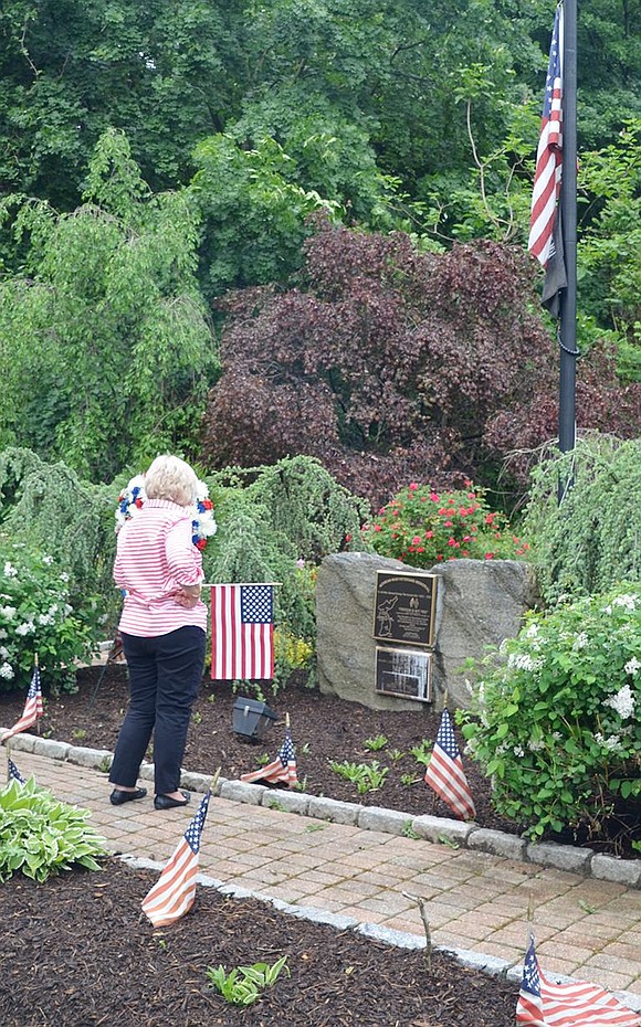 <p class="Picture">Patricia DeLuca gazes at the plaque at the entrance to Crawford Park honoring local veterans who were killed or missing in action in Korea, among them her brother, Anthony Cotroneo. DeLuca, whose parents owned Modern Shade and Awning on Main Street, is grateful for the beautiful Korean War monument and how nicely it is maintained.</p>