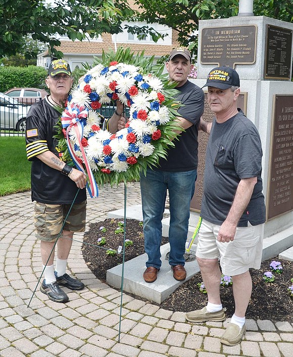 <p class="Picture">Vietnam veterans Tom Giorgi, Peter Sileo and Steve Vespia place a memorial wreath in front of the monument naming those who died in World War II and the Korean War at Veterans&rsquo; Memorial Park.</p>